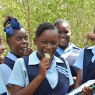 Students taste a mangrove leaf -they\'re salty!