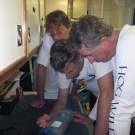 Andrew Bruckner, Brian Beck, and Phil Renaud read information gatherd from a meter on the previous dives.