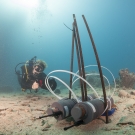 A science team member working with new underwater equipment.