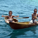 Kia village boys in relaxing in their dugout canoes. 