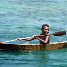 The children were racing their dugout canoes. 