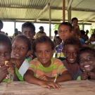 Primary students gather around at Dunde School. 