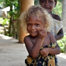 The warm welcome of a smile from a young girl in Nazareth community. 