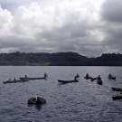 Dugout canoes lining up to get a closer look at the ship.