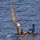 Young men enjoying a canoe ride in the windy conditions.