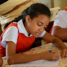 Young girl taking survey about coral reefs from GPS Neiafu