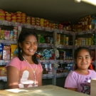 Girls tending to a local food stand.