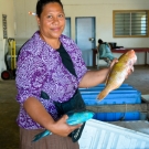 Showing off wares at the fish market.