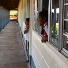 Students at GPS Liviela peaking at the courtyard to see what was going on.