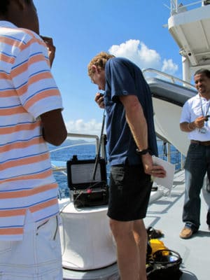 Dr. Andy Bruckner uses the base station to communicate with Phil and Amanda underwater