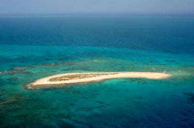 Northwest Cay, a small island with remains of an old lighthouse is located along the southern rim of Hogsty Reef, Bahamas