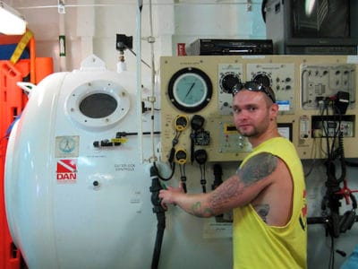 Nick Cautin, Dive Safety Officer, working on the Golden Shadow's on board recompression chamber