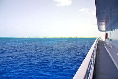 Several Australian pine trees can be seen poking up above the native trees along the Great Inagua shoreline from the Golden Shadow
