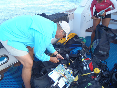 Dave Grenda and Krista Sherman with their SCUBA gear and survey equipment.