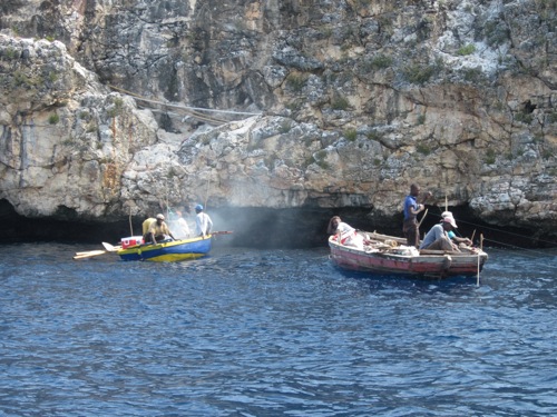 Haitian fishers having breakfast in Lulu Bay. They eat, fish, and sleep on their boats.
