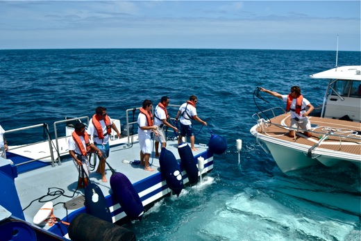 The Golden Shadow's crew bringing in the Calcutta to the moon pool loading platform