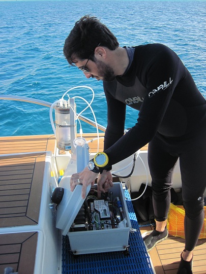 Dr. Ian Enochs prepares his equipment to measure the water’s chemistry at each dive site.