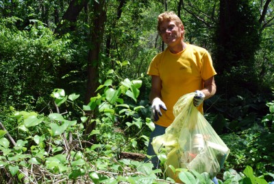 Dr. Andy Bruckner filling one of many garbage bags during our wetland cleanup