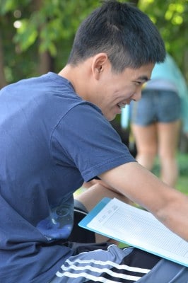 NOSB Competition student happily documents coral reef survey data.jpg