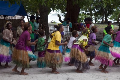 Women dancing to the bamboo band.