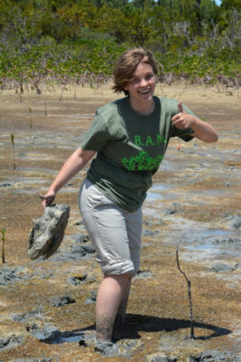 Even after sinking in the mud, this Forest Heights Academy student is excited to plant her mangroves.