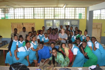 Photo 1 - Intern Maggie Dillon, William Knibb High School (left) students, and St. Hilda High School (right) students in the Year 1 J.A.M.I.N. program pose for a photo after a successful day of learning about the mangrove food web.