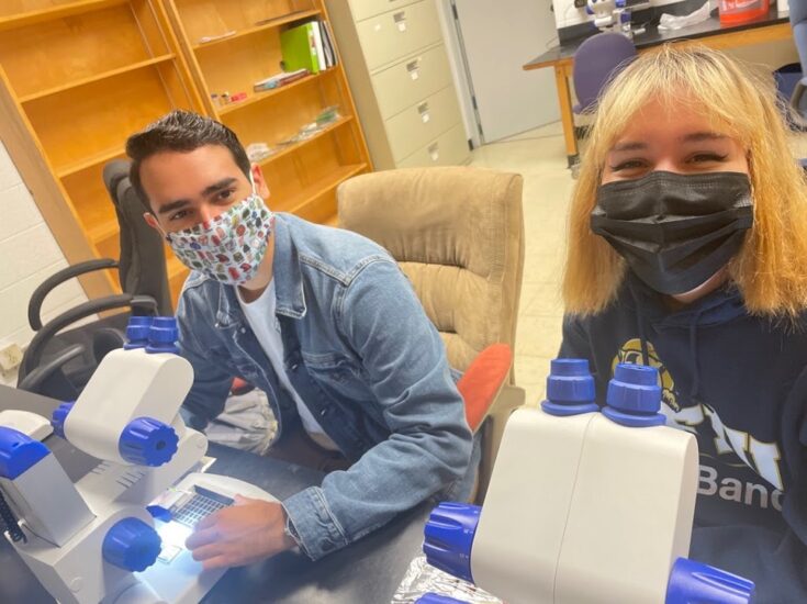 Figure 1: Undergraduate students, Mathew Ponce and Katherina Arista, sorting sediments in the early stages of the Foram Lab.