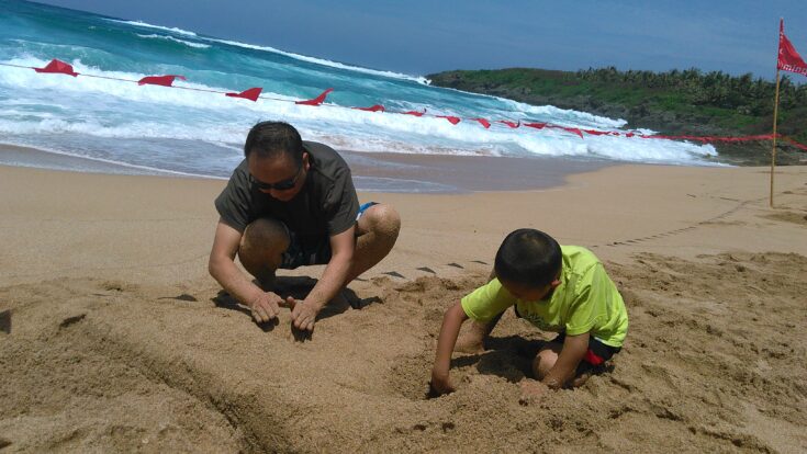 Yanjun Mao at beach  with father