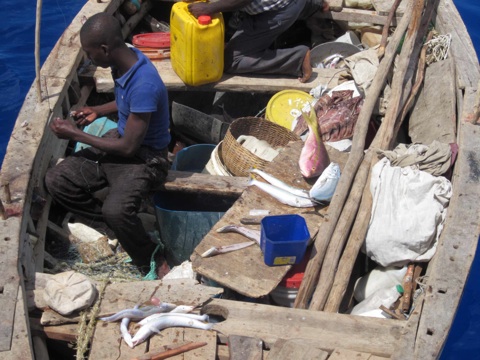 Fishers from Haiti will spend their time fishing and sleeping on a small boat.