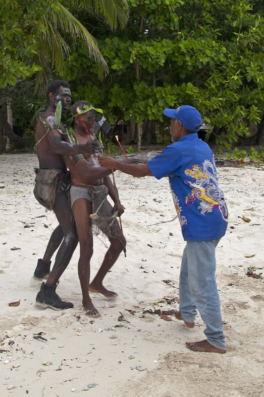 Chief John offering a sign of peace with feather money.
