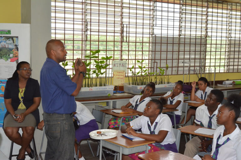 marine scientist teaching Jamaican students about sea urchins