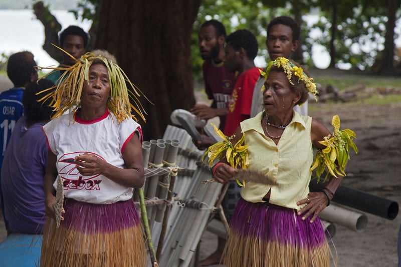 Women dancing to the bamboo band.