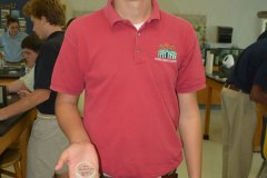 B.A.M. year 2 student from Forest Heights Academy proudly shows off his plated mangrove leaf. Now all he has to do is wait to see if fungus will begin to grow.